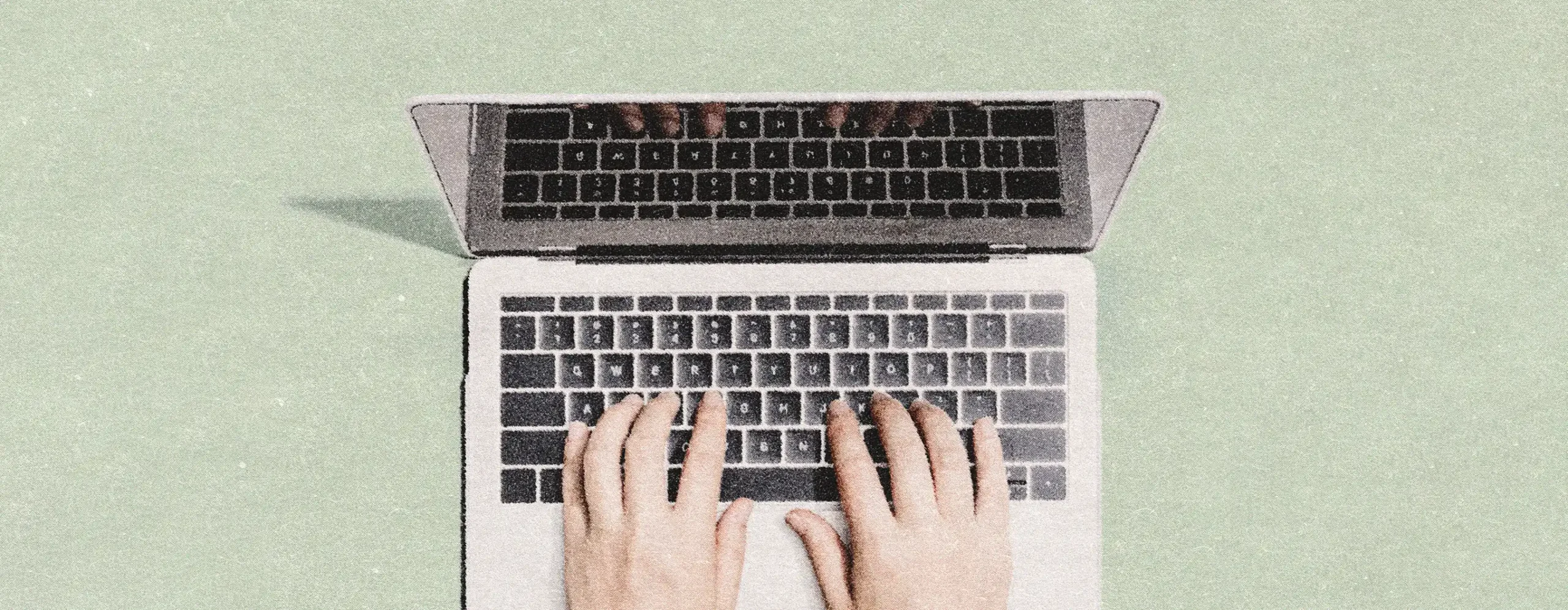 Hands typing on a laptop